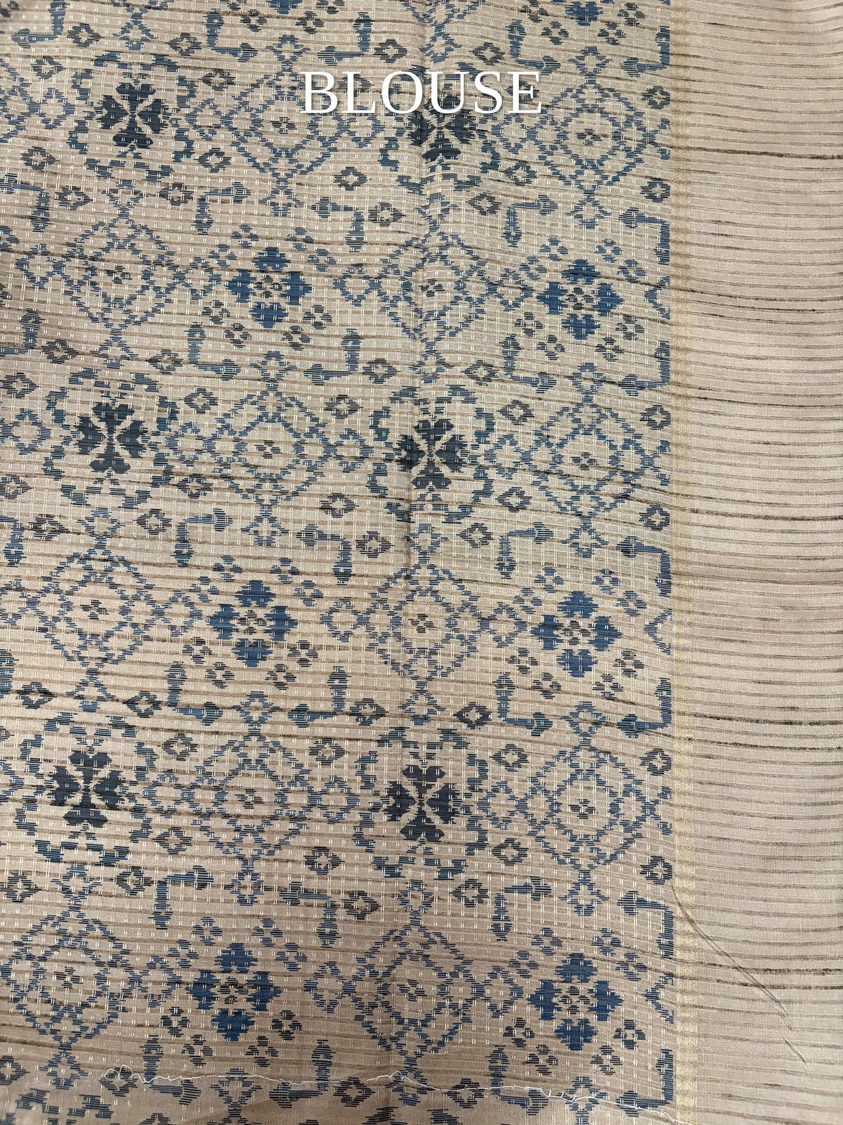 Beige blouse piece with blue geometric motifs
